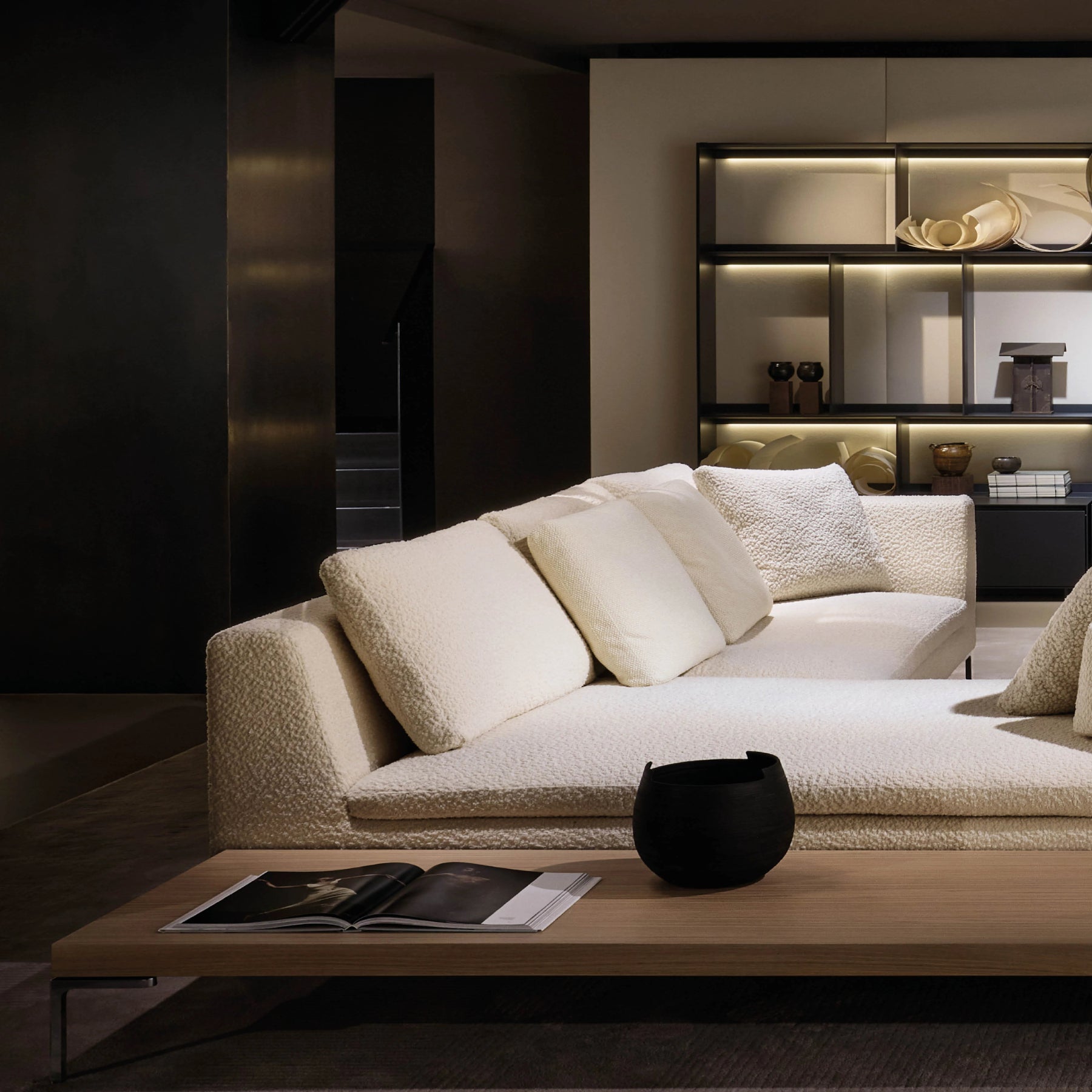 Modern living room with a beige sofa, coffee table, and decorative items.